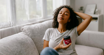 Person relaxing at home holding MONTKUSH True Vibe Gummies for stress relief before the weekend