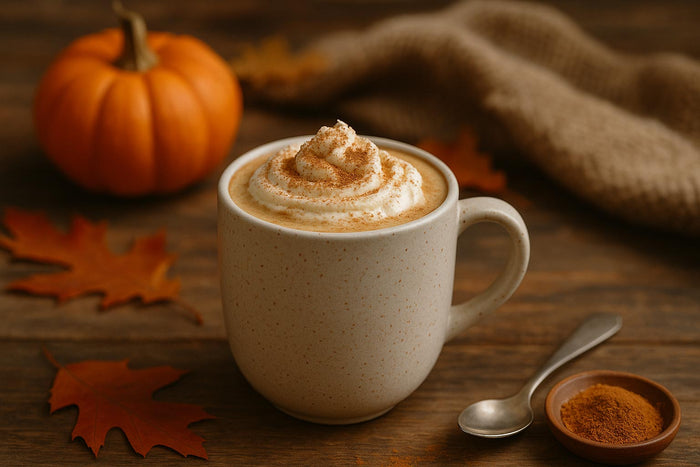 Pumpkin spice latte with whipped cream in a cozy autumn setting, perfect fall CBD recipe