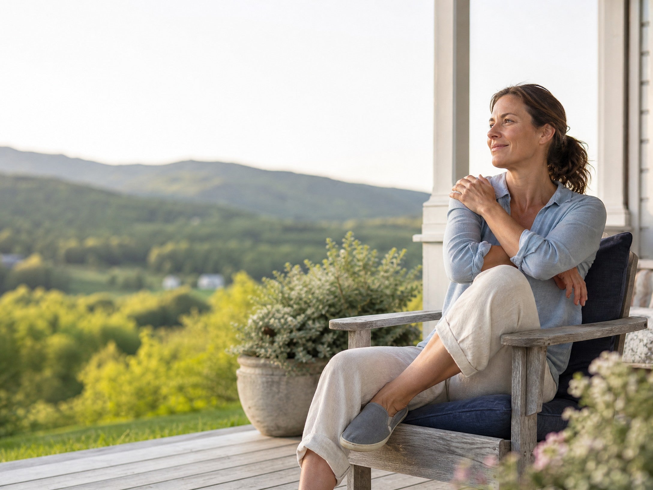Adult relaxing on a porch overlooking Vermont hills